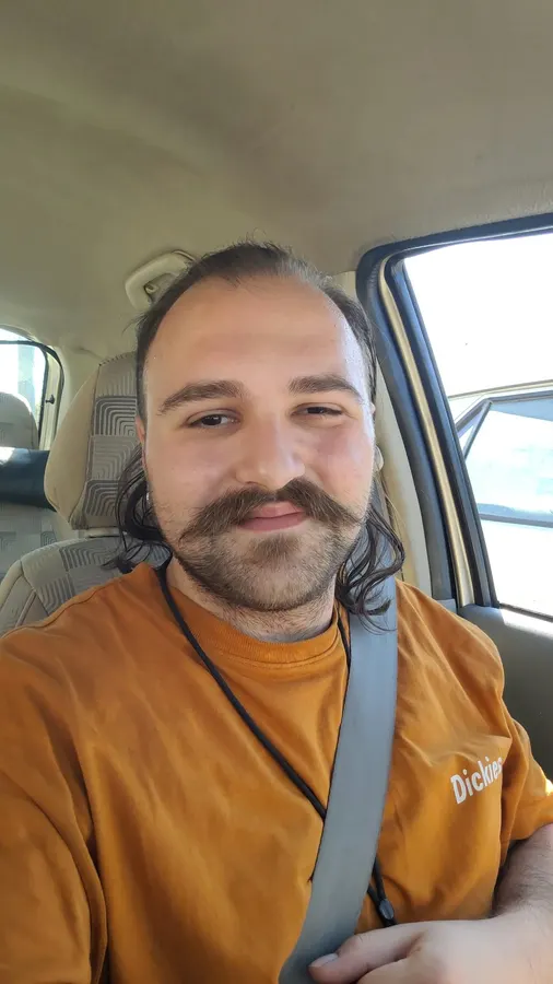 Arif Çelebi Metin in a car, smiling