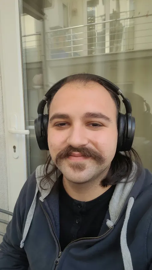 Arif Çelebi Metin, wearing headphones