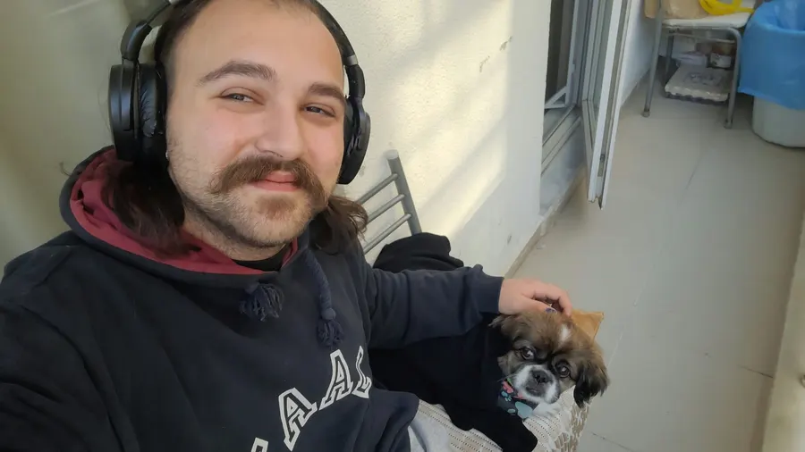 Arif Çelebi Metin on a balcony with a dog